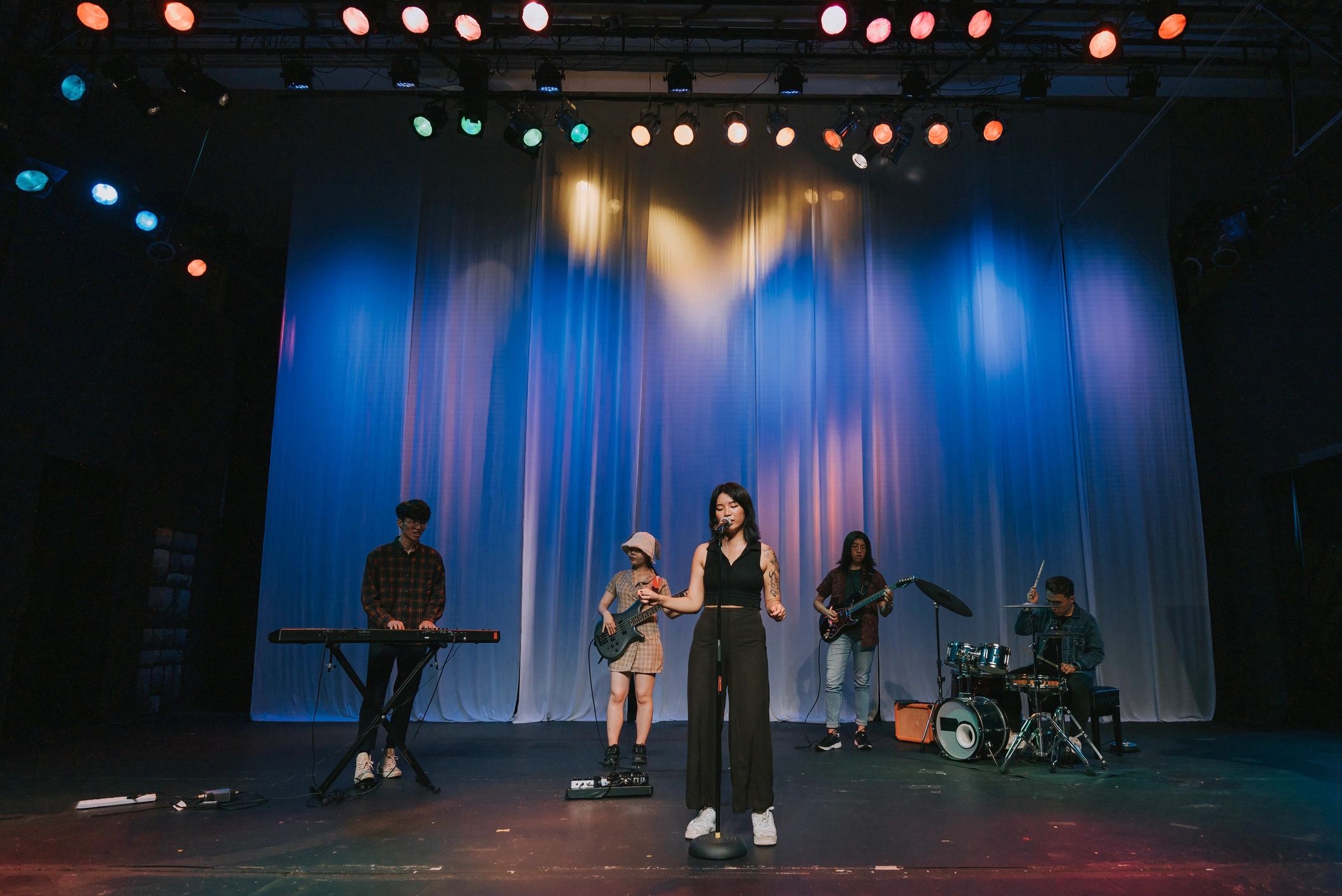 Rock band performing under bright stage lights