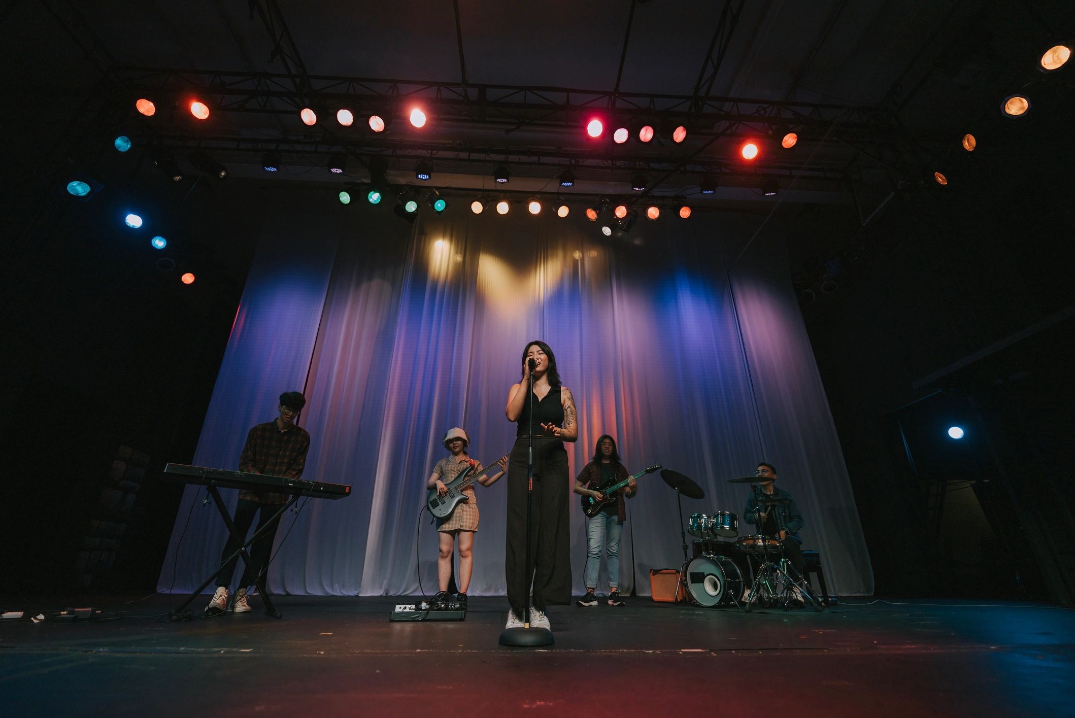Live concert stage with energetic band and crowd